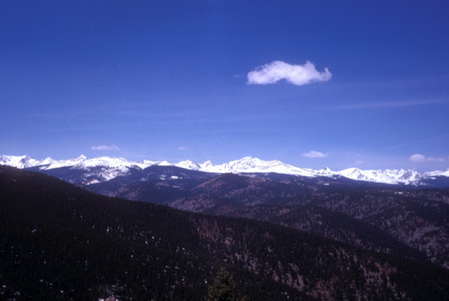 Colorado mountain landscape with single white cloud in blue sky