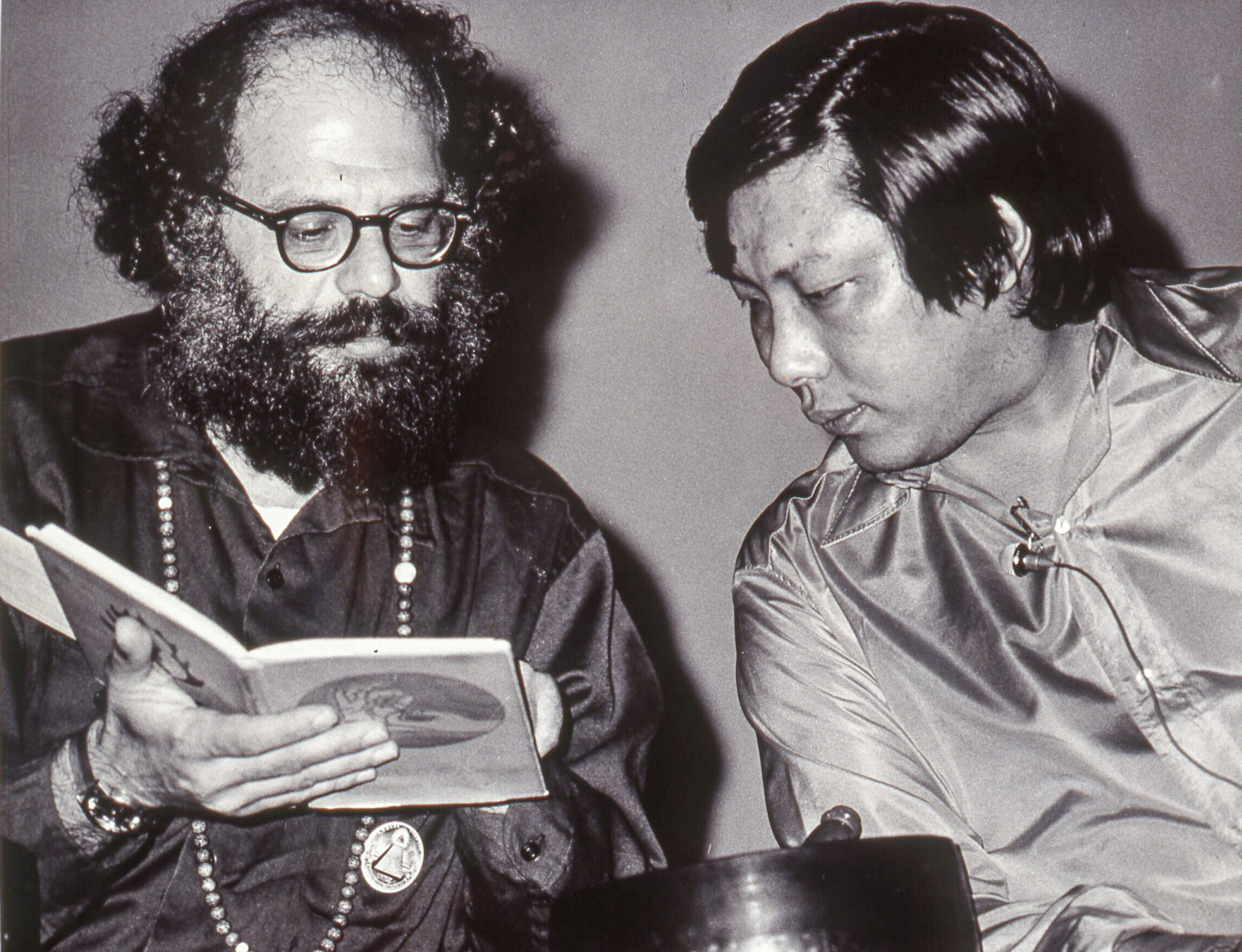 Allen Ginsberg and Chogyam Trungpa, circa 1972, looking at a copy of the poetry book, "Mudra"